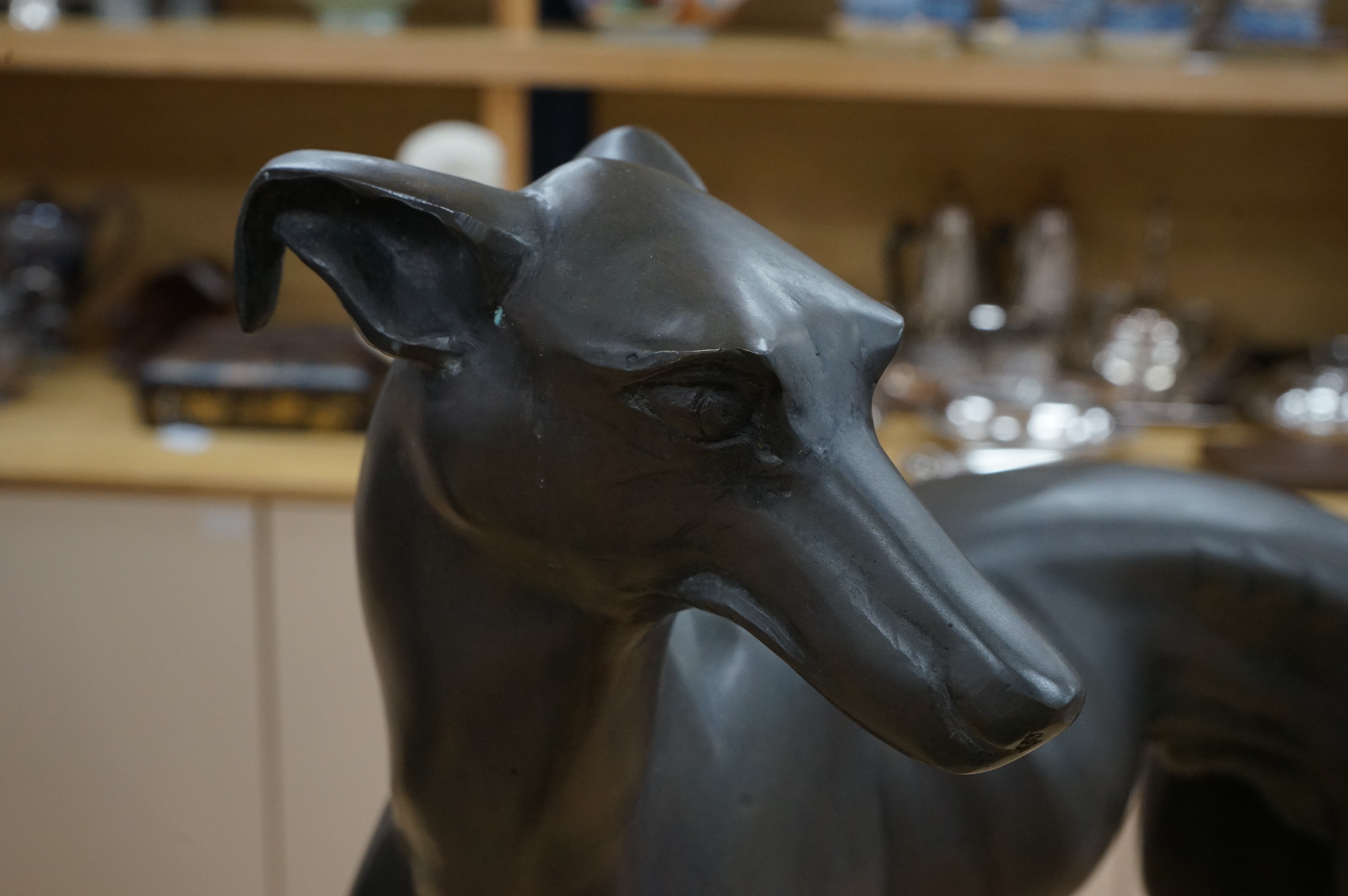 A pair of modern bronze greyhounds, approximately 66cm wide x 53cm high and 49cm wide x 57cm high. Condition - good